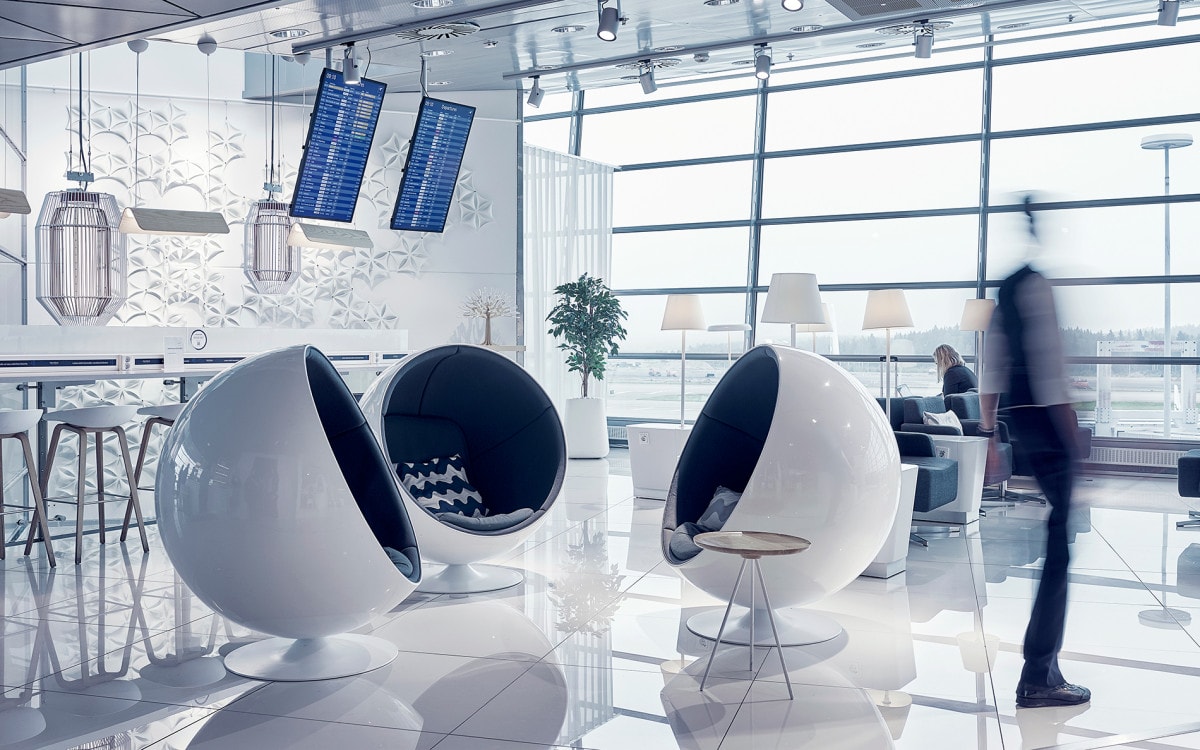 Three White Eero Aarnio Ball chairs at Finnair Schengen lounge